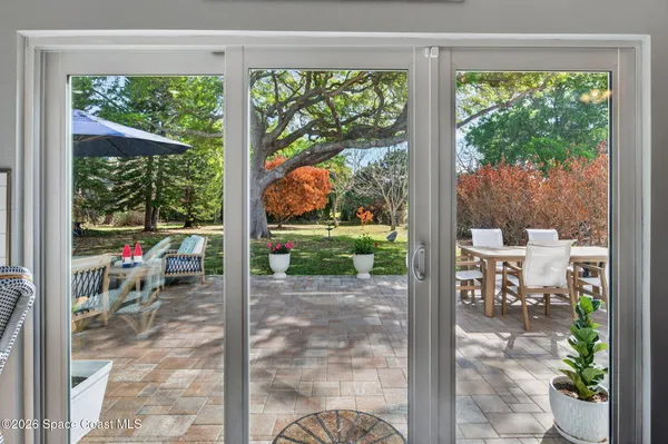 a view of a porch with chairs and backyard