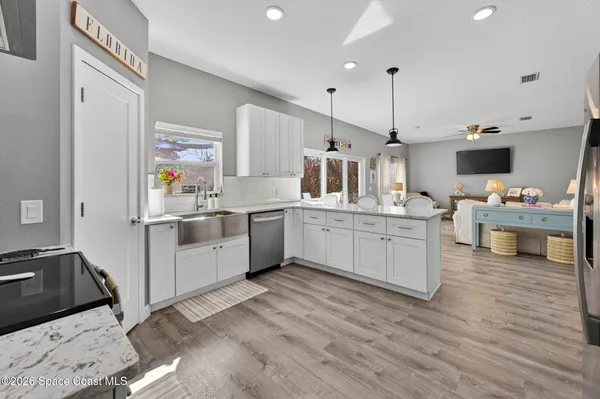 a kitchen with cabinets a sink and appliances