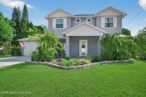 a front view of a house with a garden