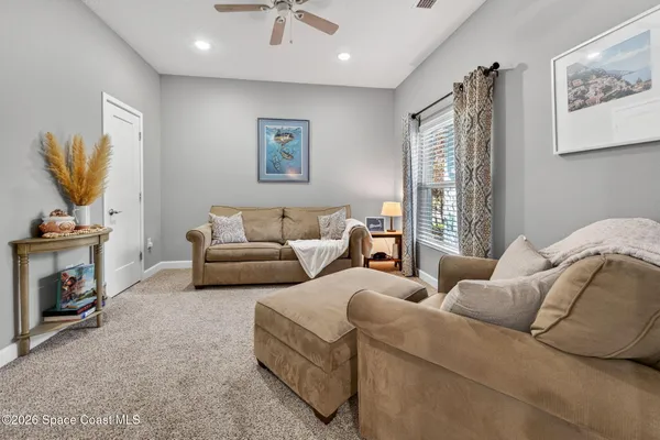 a bedroom with furniture and a flat screen tv