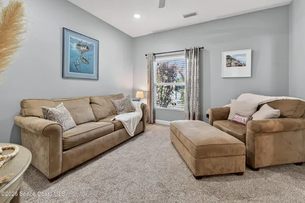 a living room with a couch and painting on the wall