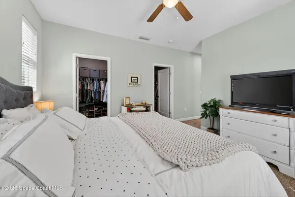 a bedroom with a bed and a flat screen tv