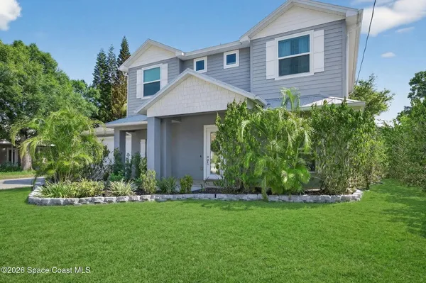 a front view of a house with a garden
