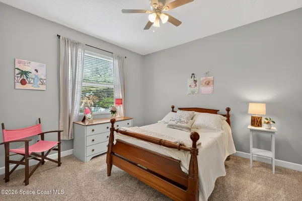 a bedroom that has a bed and a table in it