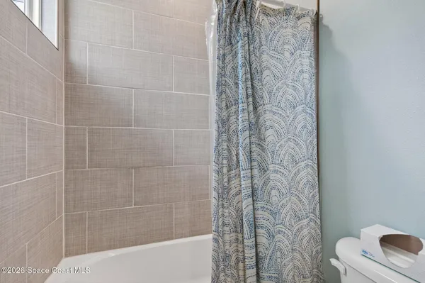 a bathroom with a shower curtain