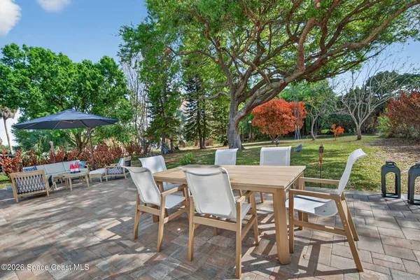 a view of a chairs and table in patio