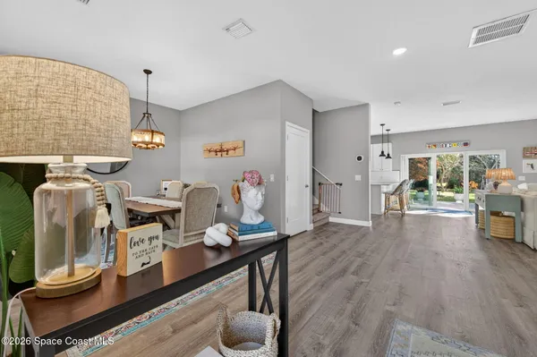 a view of a workspace with furniture and wooden floor
