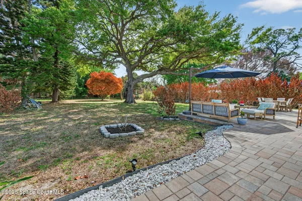 a backyard of a house with barbeque oven