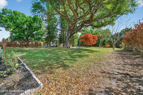 a backyard of a house with yard and outdoor seating