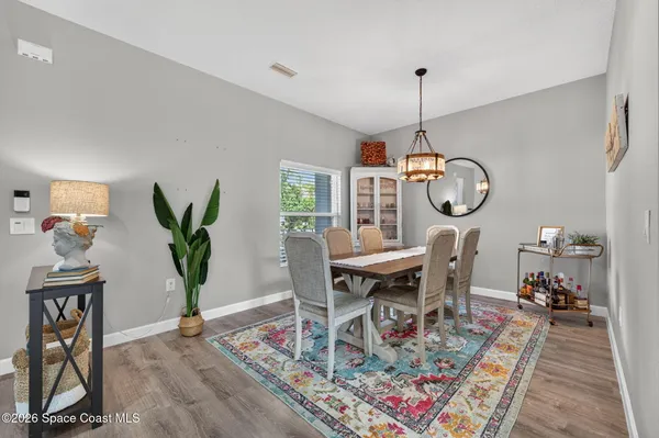 a view of a dining room with furniture window and wooden floor