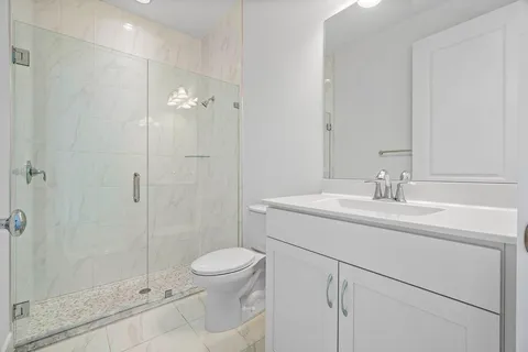 a bathroom with a sink toilet and shower