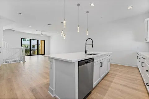 a kitchen with granite countertop a stove and a sink