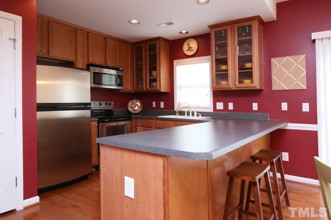 2110 Piney Brook Road, Unit 102 Raleigh, NC 27614 - Photo 9 of 24 The kitchen has stainless steel appliances, and a breakfast bar.