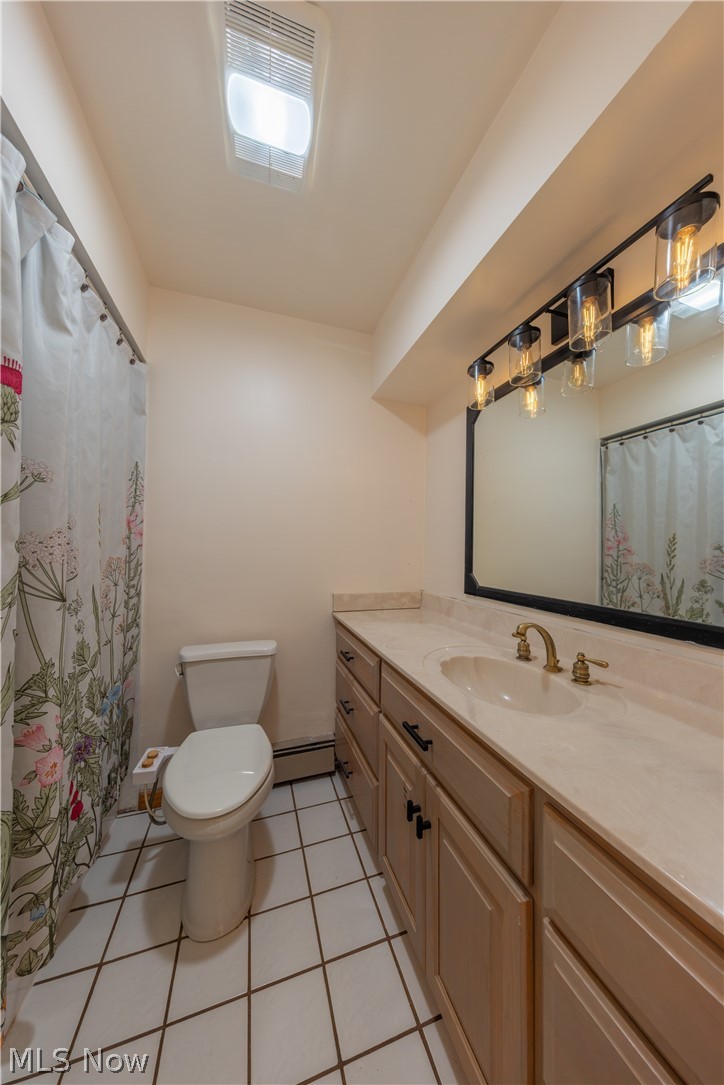 7969 Dines Road Novelty, OH 44072 - Photo 32 of 48 Bathroom featuring a light-toned vanity with an integrated sink and brass-finish faucet, a rectangular mirror, and a multi-bulb vanity light fixture