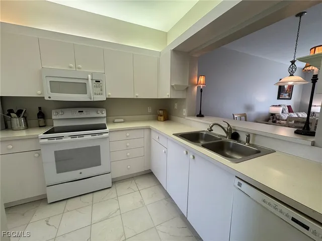 a kitchen with a sink stove and cabinets