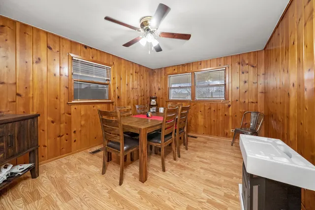 a view of a a dining room with furniture window and wooden floor