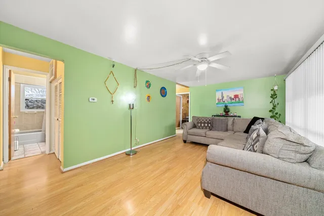 a living room with furniture and a ceiling fan