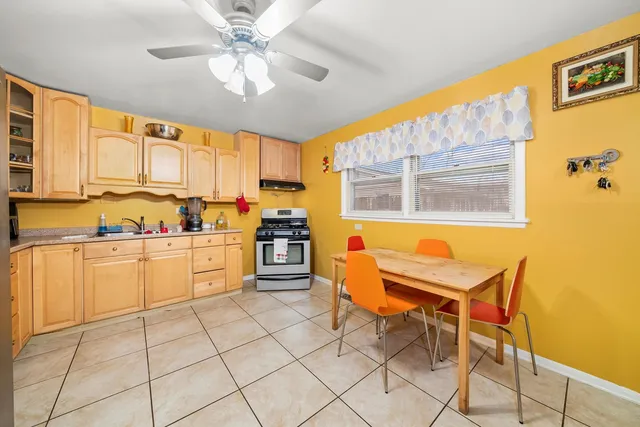 a kitchen with a stove a sink and cabinets