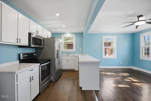 a kitchen with stainless steel appliances a refrigerator stove and microwave