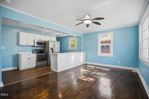 a view of a kitchen with cabinets and wooden floor