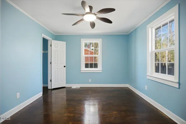 a view of a kitchen with refrigerator and wooden floor