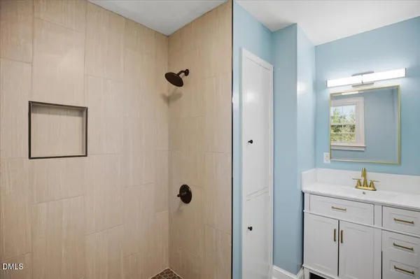 an empty room with wooden floor and a ceiling fan