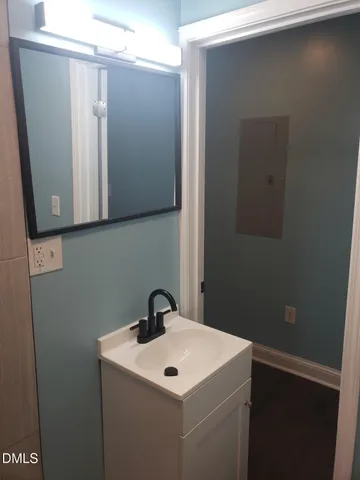 a bathroom with a sink and mirror