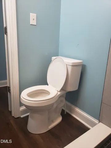 a white toilet sitting next to a white sink