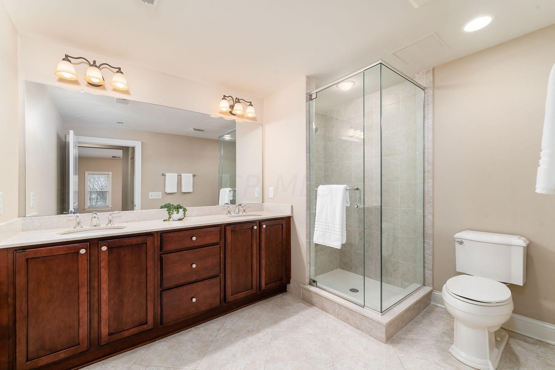 3175 Tremont Road, Unit 311 Columbus, OH 43221 - Photo 13 of 26 Large primary bathroom with double sinks and walk-in shower