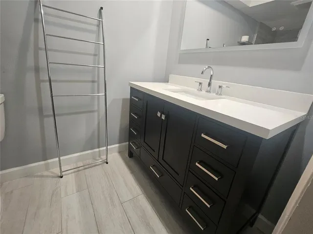 a kitchen with a sink and a mirror