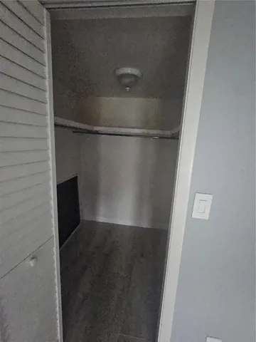 a view of walk in closet with empty racks