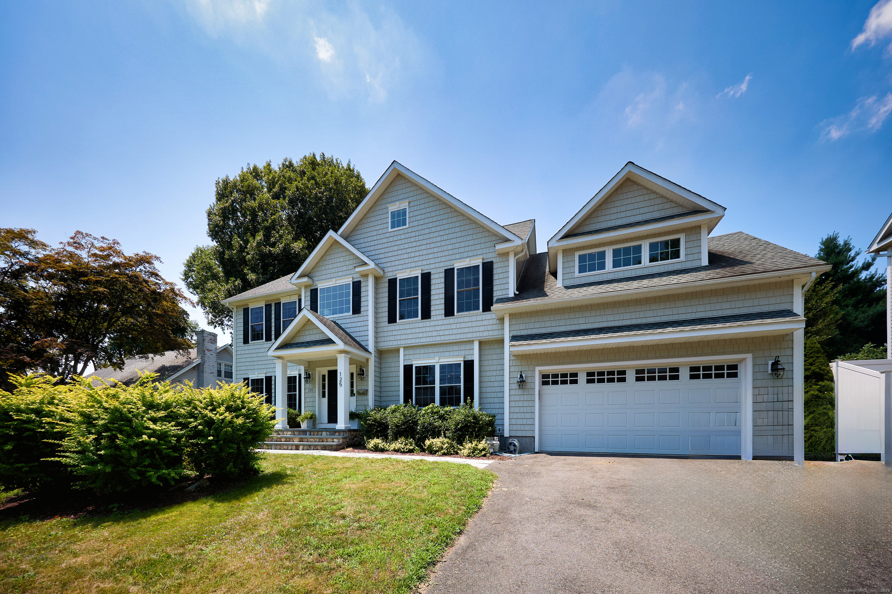 125 Mayweed Road Fairfield, CT 06824 - Photo 1 of 1 a front view of a house with a yard and garage