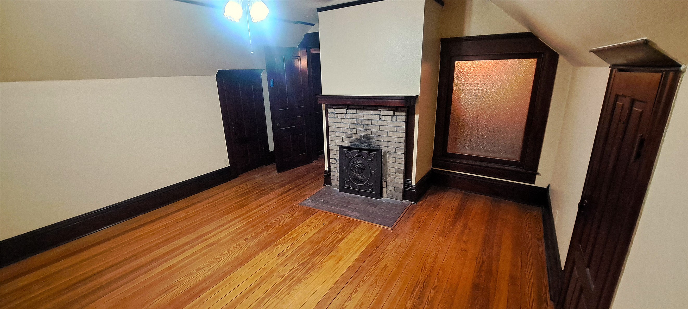 105 Davis Drive Thorndale, TX 76577 - Photo 20 of 21 Gleaming hardwood floors and a classic brick fireplace anchor this upper-level room.