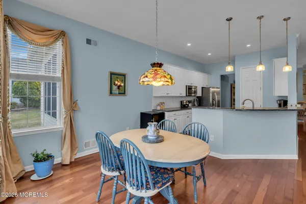 a view of a dining room with furniture window and wooden floor