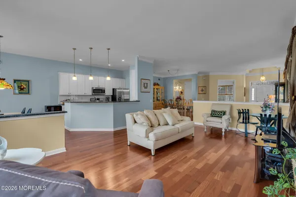 a living room with furniture and kitchen view