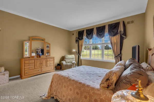 a bed room with a bed and a dresser