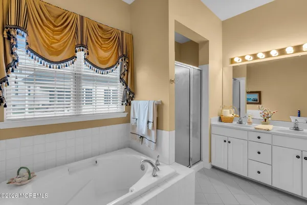 a bathroom with a bathtub a sink and a window