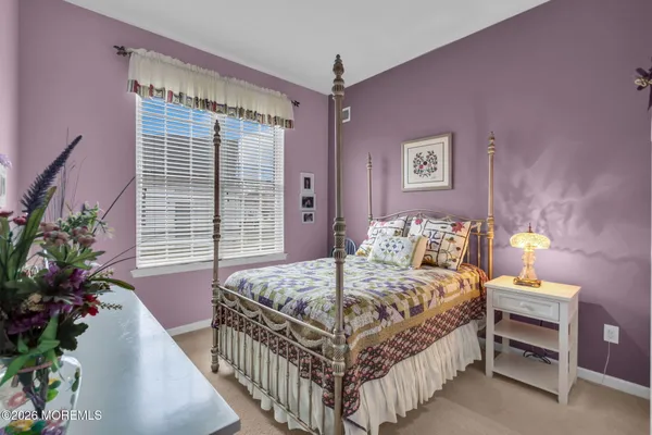 a bedroom with a bed and a potted plant