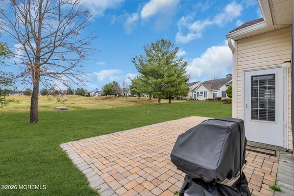 a view of a backyard with sitting area