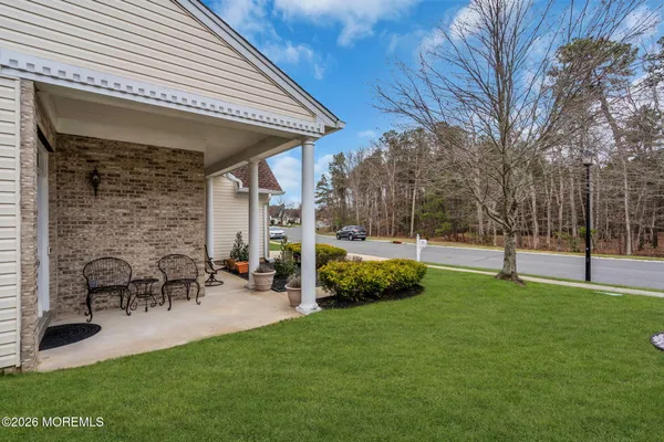a view of a house with a backyard patio and sitting area