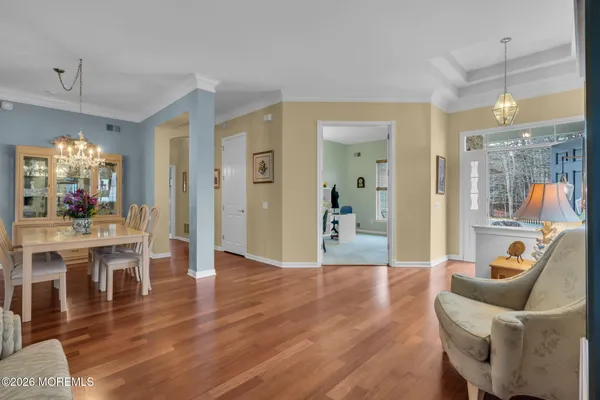 a living room with furniture wooden floor and a view of kitchen