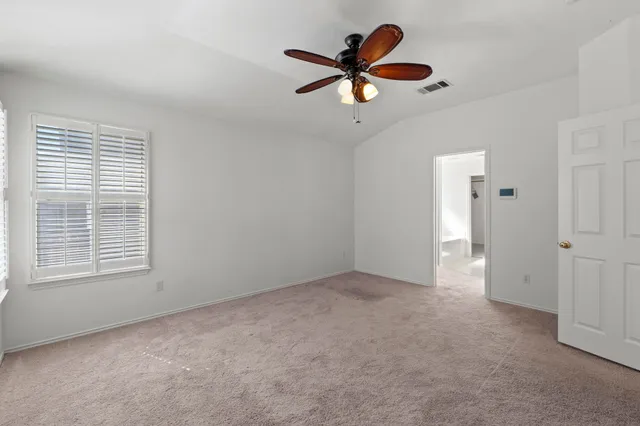 a spacious bathroom with a double vanity sink a large mirror and a shower