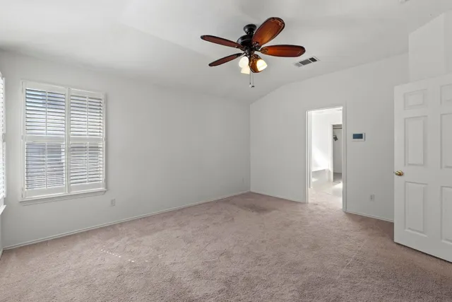 a spacious bathroom with a double vanity sink a large mirror and a shower