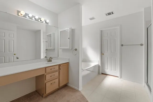 a bathroom with a tub and sink