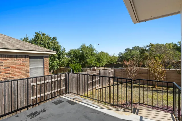 a view of a balcony with wooden fence and floor