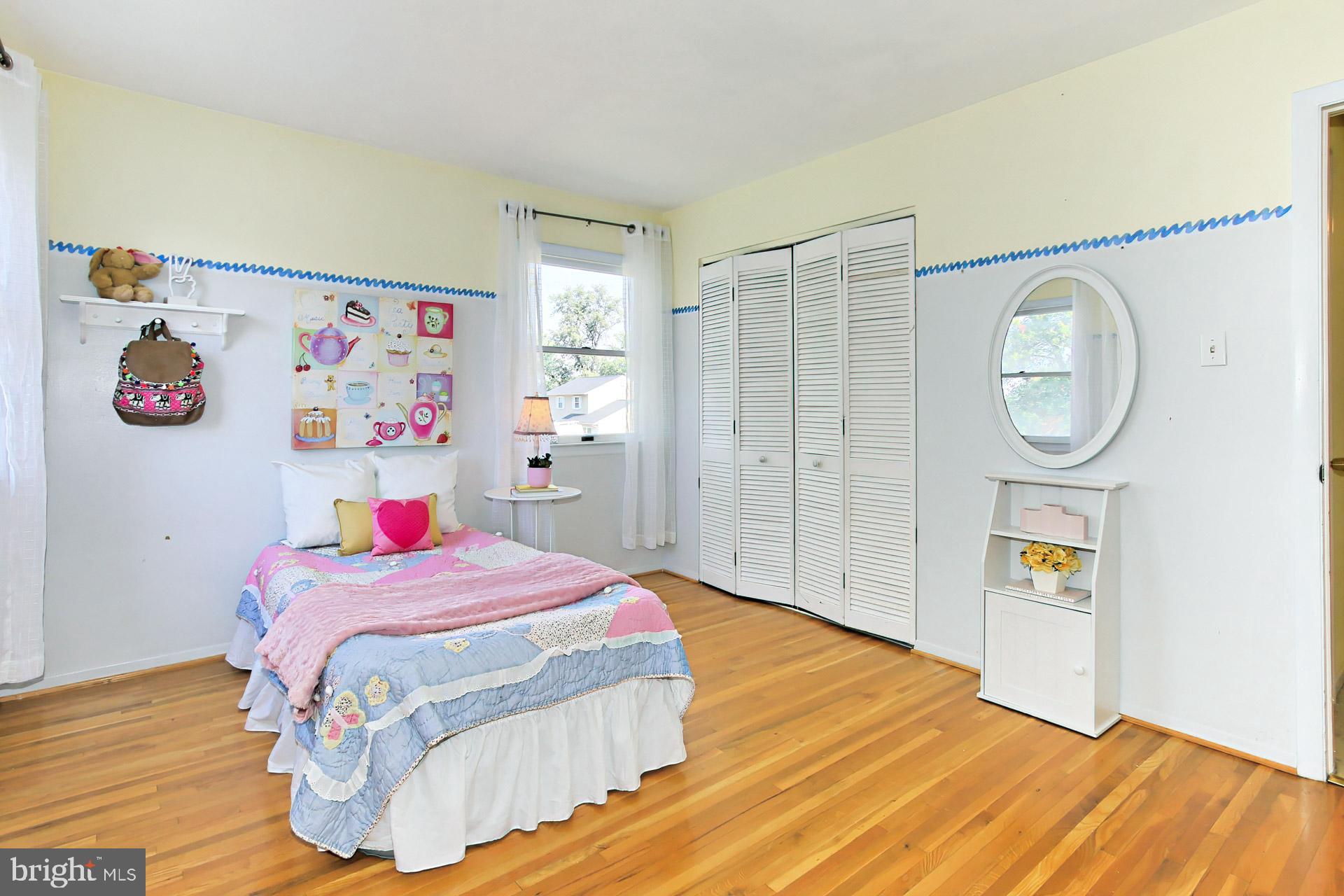 4123 Lees Corner Road Chantilly, VA 20151 - Photo 34 of 47 a bedroom with a bed a clock on the wall and dresser
