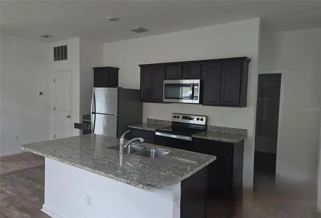 a bathroom with a sink a toilet and bathtub