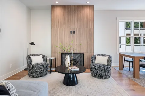 a living room with furniture a fireplace and a table