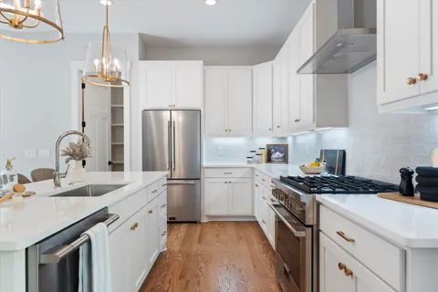 a kitchen with a sink stove and refrigerator