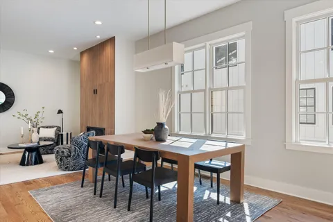 a view of a a dining room with furniture window and wooden floor